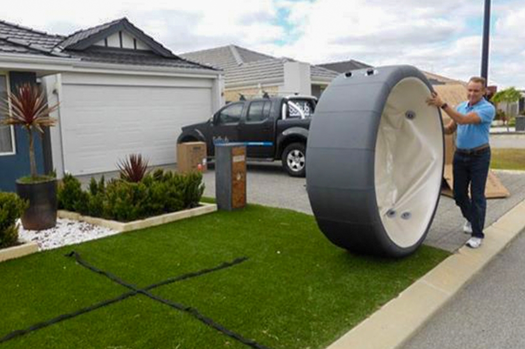 Portable hot tub being installed in a small backyard